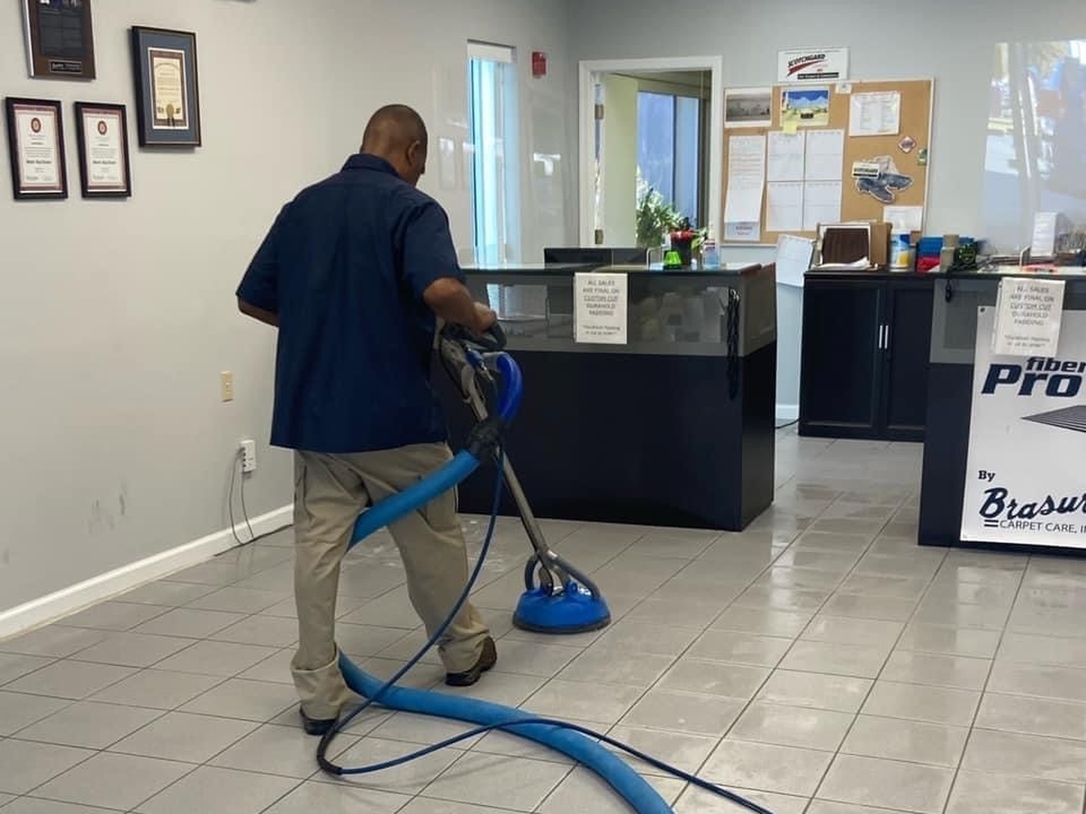 Grout Cleaning - A man cleaning the floor